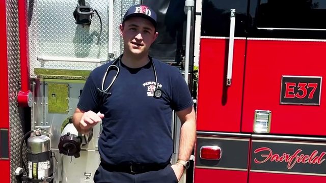 Fairfield Fire Department paramedic intern Dawson Deldotto standing beside Engine 37